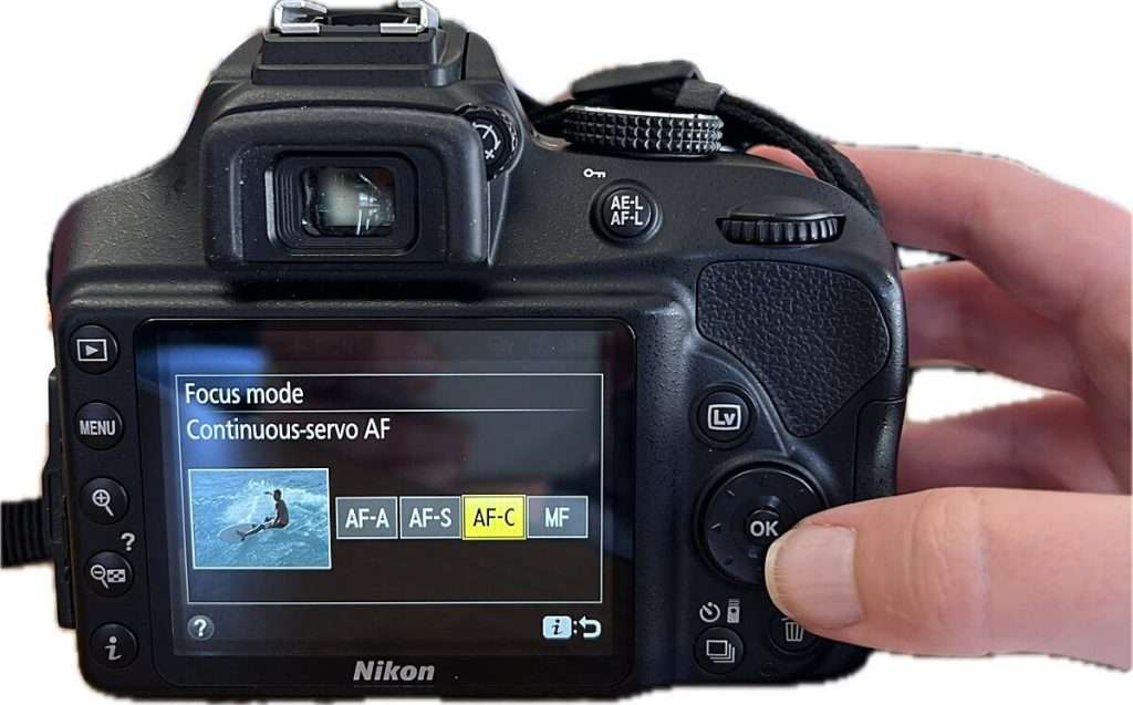 Camera screen displaying focus mode options with "AF-C" highlighted and labels "AF-A AF-S AF-C MF" visible, demonstrating continuous autofocus selection in camera settings for beginners.